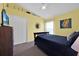 Cozy bedroom with neutral carpet, queen bed, and natural light from the window at 2627 Autumn Creek Cir, Kissimmee, FL 34747