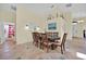 Dining room features a large wooden table with seating for eight and tile flooring at 2627 Autumn Creek Cir, Kissimmee, FL 34747