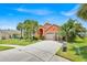 Lovely home featuring a well-kept lawn and mature palm trees in a desirable neighborhood at 2627 Autumn Creek Cir, Kissimmee, FL 34747