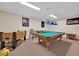 Spacious game room featuring a pool table and foosball for Gathering fun and entertainment at 2627 Autumn Creek Cir, Kissimmee, FL 34747