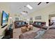 Open concept living room with comfortable leather sofas, skylights, and neutral tile flooring at 2627 Autumn Creek Cir, Kissimmee, FL 34747