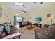 Cozy living room with comfortable leather seating and a large TV at 2627 Autumn Creek Cir, Kissimmee, FL 34747
