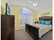 Bright and airy main bedroom with a vaulted ceiling, large window, and comfortable furnishings at 2627 Autumn Creek Cir, Kissimmee, FL 34747