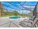 Backyard oasis featuring a pool, hot tub, lounge chairs, and a spacious patio for outdoor relaxation at 2627 Autumn Creek Cir, Kissimmee, FL 34747