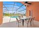 Outdoor living area featuring a sparkling pool inside a screened enclosure at 2627 Autumn Creek Cir, Kissimmee, FL 34747