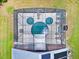 Aerial view of a Mickey Mouse-shaped pool inside a screened enclosure with sun loungers on the pool deck at 2627 Autumn Creek Cir, Kissimmee, FL 34747