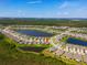 Aerial view of community with lush landscaping, tranquil ponds, and well-spaced homes at 2793 Nature View Rd, St Cloud, FL 34771