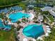 Expansive community pool featuring multiple swimming areas, sunbathing spots, and mature landscaping at 2793 Nature View Rd, St Cloud, FL 34771