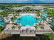 Breathtaking aerial view of a lavish community pool surrounded by palm trees and lounge areas at 2793 Nature View Rd, St Cloud, FL 34771