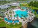 Stunning aerial view of a resort-style community pool area with lounge chairs and palm trees at 2793 Nature View Rd, St Cloud, FL 34771