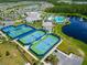 Aerial view showcasing community tennis courts, pool, clubhouse and green spaces with mature landscaping at 2793 Nature View Rd, St Cloud, FL 34771