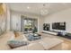 Bright living room features a large white sectional and sliding glass doors to the outdoor patio at 2793 Nature View Rd, St Cloud, FL 34771