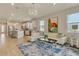 Open-concept living room and kitchen area with wood-look tile and modern white kitchen cabinets at 2793 Nature View Rd, St Cloud, FL 34771