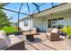 Relaxing screened-in patio with brick flooring, stylish seating, and view of the well-maintained lawn at 2793 Nature View Rd, St Cloud, FL 34771