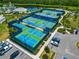 Aerial view of well-maintained tennis and pickleball courts surrounded by lush landscaping at 2793 Nature View Rd, St Cloud, FL 34771