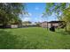 Home boasts a huge grassy backyard with storage shed and covered patio at 2822 Fulford St, Deltona, FL 32738