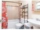Cozy bathroom featuring tiled walls, a shower-tub combo, and stylish shelving for storage at 2822 Fulford St, Deltona, FL 32738