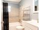Well-maintained bathroom with shower-tub, updated fixtures, and shelving for storage at 2822 Fulford St, Deltona, FL 32738
