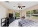 Bedroom features sliding door with exterior access, ceiling fan and closet at 2822 Fulford St, Deltona, FL 32738