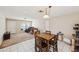Dining room with a wooden table and chairs, flowing into a carpeted living area at 2822 Fulford St, Deltona, FL 32738