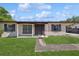 Charming single-story home featuring a covered front porch and a well-maintained front yard at 2822 Fulford St, Deltona, FL 32738