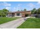 Charming single-story home featuring a covered carport and a well-maintained front yard at 2822 Fulford St, Deltona, FL 32738