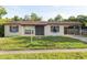 Charming single-story home featuring a covered carport, neutral paint, and a well-maintained front yard at 2822 Fulford St, Deltona, FL 32738