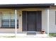 Inviting front door with sidelight windows, a covered porch, and the house number displayed at 2822 Fulford St, Deltona, FL 32738
