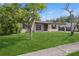Charming single-story home with a well-manicured lawn and mature tree at 2822 Fulford St, Deltona, FL 32738