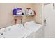 Convenient laundry room with washer, dryer, and storage shelving at 2822 Fulford St, Deltona, FL 32738