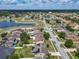 An aerial view of a residential neighborhood featuring a beautiful community pond at 2860 Orange Haven Way, Kissimmee, FL 34746