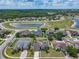 Aerial view of property in a community close to a pond and featuring manicured lawns at 2860 Orange Haven Way, Kissimmee, FL 34746