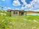Home with a beautiful, solar-paneled backyard featuring a covered patio at 2860 Orange Haven Way, Kissimmee, FL 34746