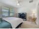This bedroom includes two large windows, a ceiling fan, and a TV in the corner of the room at 2860 Orange Haven Way, Kissimmee, FL 34746