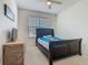 This bedroom is well lit, featuring carpet flooring and a dresser with a television at 2860 Orange Haven Way, Kissimmee, FL 34746