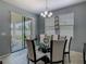 The dining room features a modern chandelier and a glass table with white chairs at 2860 Orange Haven Way, Kissimmee, FL 34746