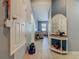 Hallway with tiled flooring leading to the living area, featuring a decorative table and a view of the living room at 2860 Orange Haven Way, Kissimmee, FL 34746