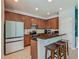 Features stainless steel appliances, tiled flooring, and dark counter tops with bar seating at 2860 Orange Haven Way, Kissimmee, FL 34746