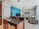 Open concept kitchen with modern features and easy access to the living room at 2860 Orange Haven Way, Kissimmee, FL 34746