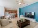 Living room view featuring open floor plan to the kitchen, complete with seating, appliances, and modern fixtures at 2860 Orange Haven Way, Kissimmee, FL 34746