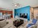 Open-concept living space with a large TV, comfortable sofas, and a seamless transition to the kitchen area at 2860 Orange Haven Way, Kissimmee, FL 34746