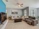 Spacious living room with tile floors, comfortable seating, and a large window providing ample natural light at 2860 Orange Haven Way, Kissimmee, FL 34746