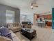 Open-concept living room with tile flooring, a ceiling fan, and a view of the adjacent kitchen and dining area at 2860 Orange Haven Way, Kissimmee, FL 34746
