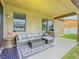Cozy covered patio with comfortable seating and a grill for outdoor cooking at 2860 Orange Haven Way, Kissimmee, FL 34746