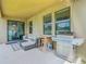 Relaxing covered patio with an outdoor kitchen and comfortable seating at 2860 Orange Haven Way, Kissimmee, FL 34746