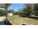 The expansive backyard features storage sheds and ample green space, offering practical storage and outdoor enjoyment at 30965 E Thyme Ave, Eustis, FL 32736