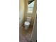 Clean bathroom featuring tile flooring and a toilet in a neutral color palette at 30965 E Thyme Ave, Eustis, FL 32736
