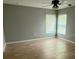 Bedroom with hardwood floors and natural light from the window at 30965 E Thyme Ave, Eustis, FL 32736