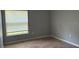 Bedroom with hardwood floors and natural light from the window at 30965 E Thyme Ave, Eustis, FL 32736