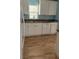 The kitchen features white cabinets, tile flooring and stainless steel appliances at 30965 E Thyme Ave, Eustis, FL 32736